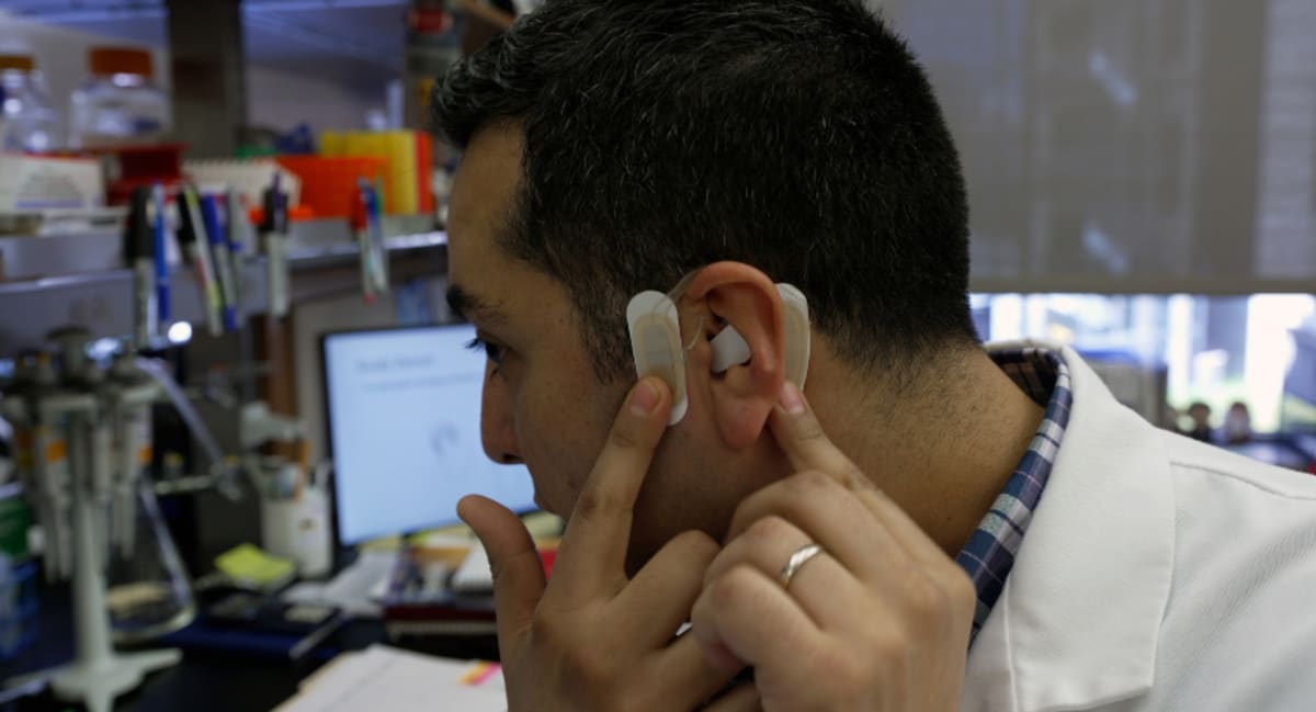 Small wearable medical device designed to attach to human ear for nerve stimulation