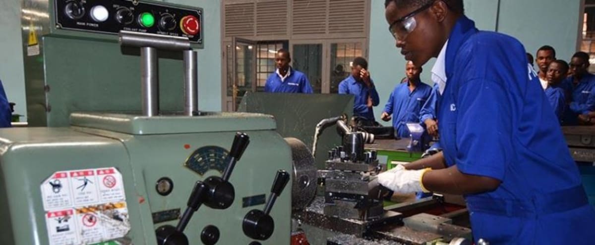 Construction workers breaking ground at new vocational training center site in Ghana