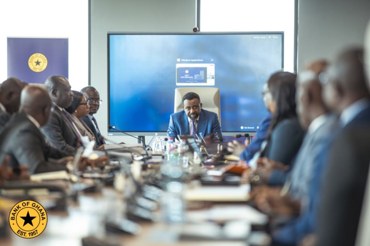 People shopping at a busy Ghanaian market showing economic activity and consumer confidence