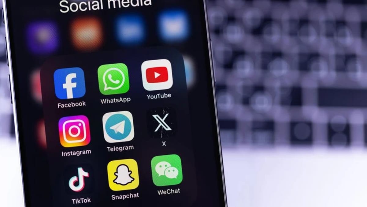 Person holding smartphone with social media apps, representing user control over digital content feeds