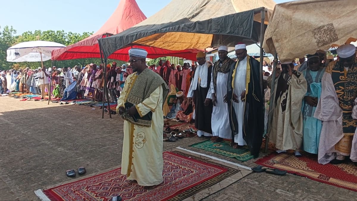 ** Large crowd of Muslims in white clothing gathered for outdoor Eid prayers in Wa, Ghana