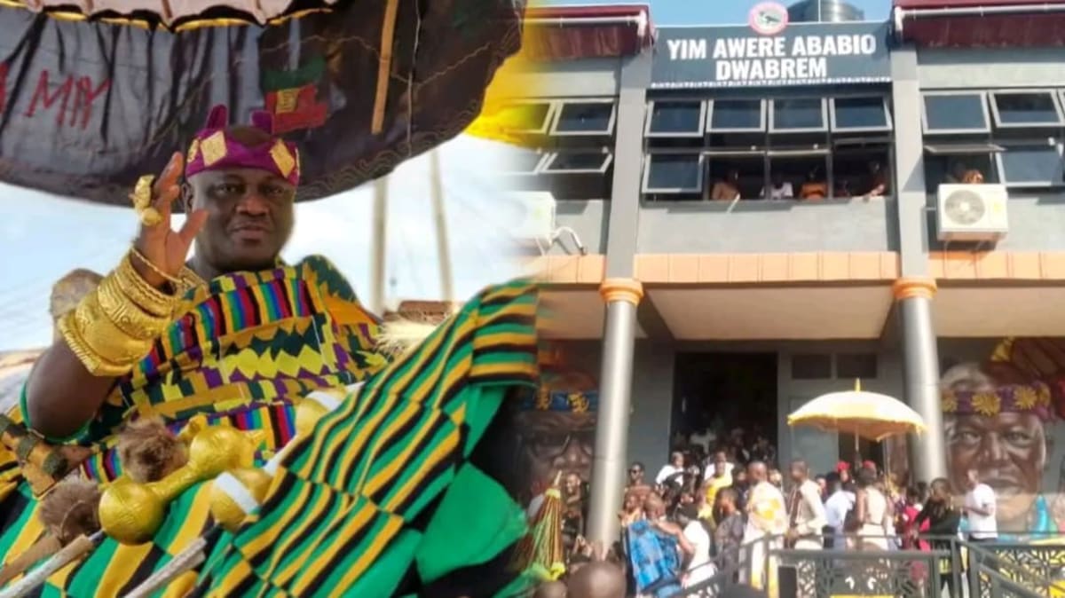 Traditional Ghanaian chief in ceremonial attire at modern community center opening ceremony