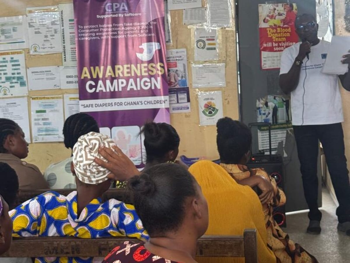 Healthcare workers educating mothers about identifying fake baby diapers at Ghanaian hospital