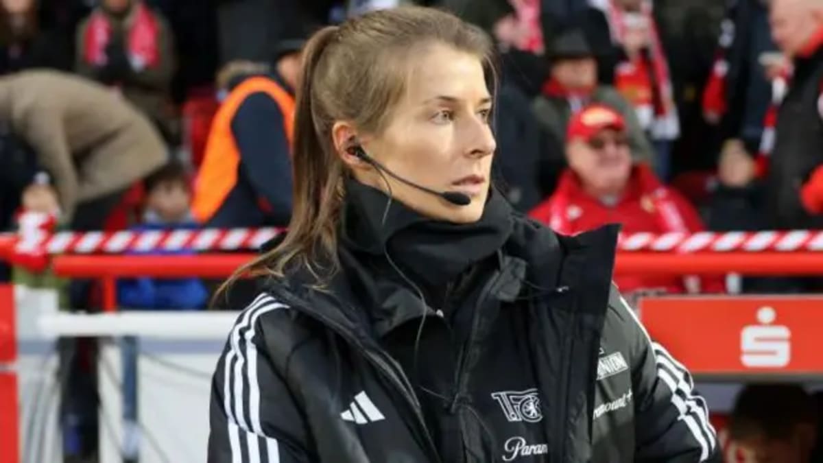 Marie-Louise Eta standing on the sideline during a Bundesliga soccer match in Germany