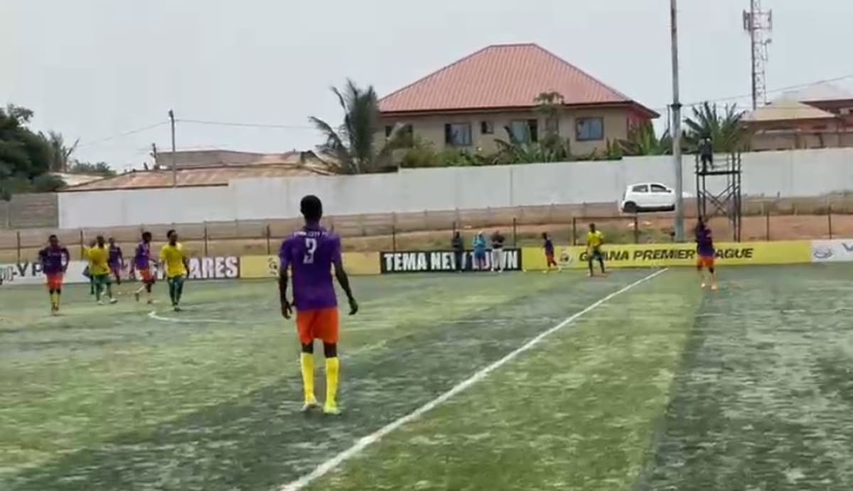 Young football players competing on field while international scouts watch from sidelines in Ghana