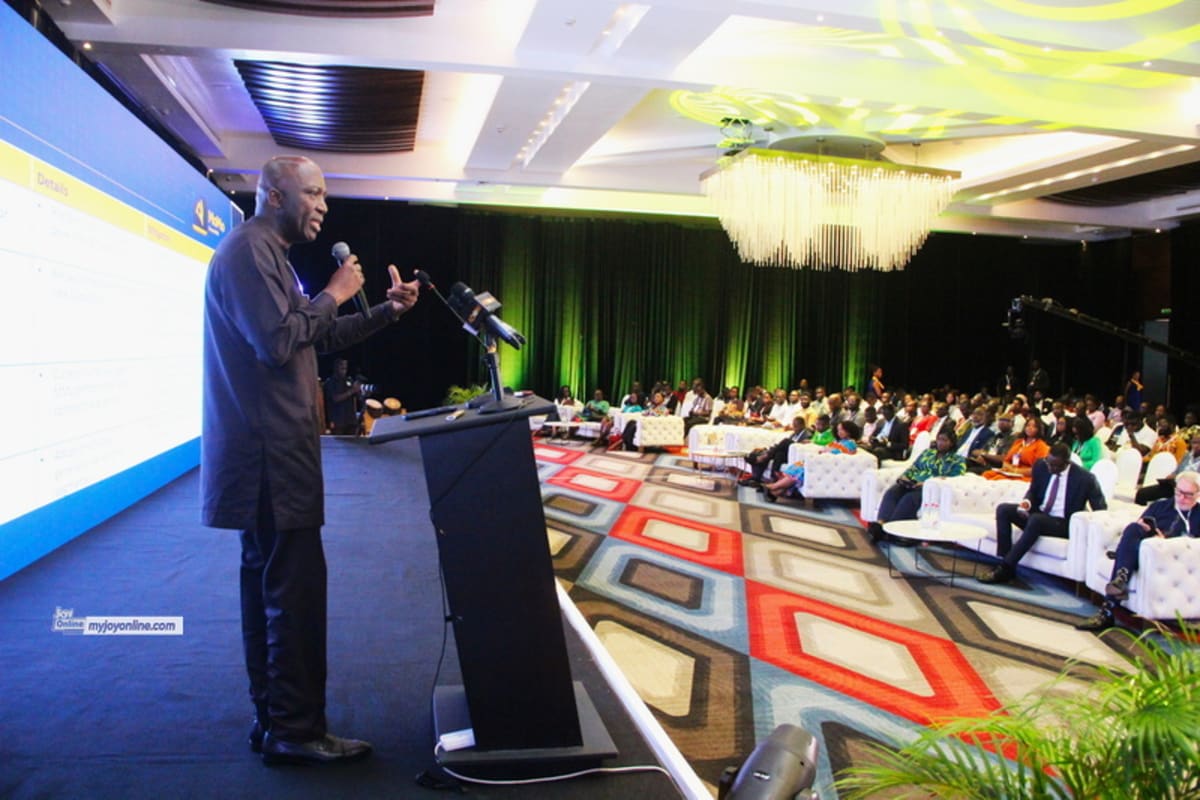 Business leaders shaking hands at fintech security conference in Accra, Ghana