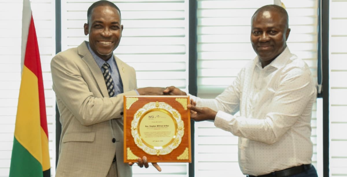Rev. Stephen Wilfred Arthur holding international aviation safety leadership award at Ghana Civil Aviation Authority headquarters