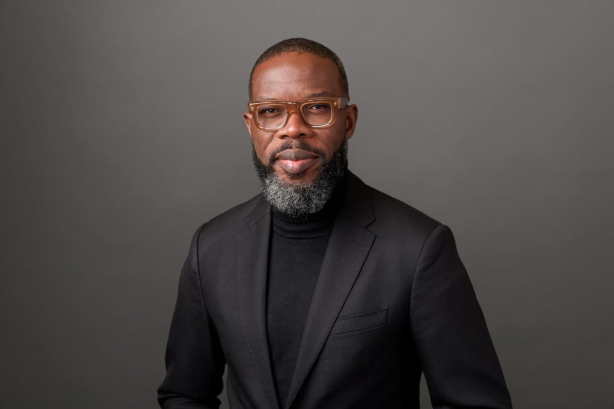 Young African professional leading a volunteer team meeting, collaborating on community project