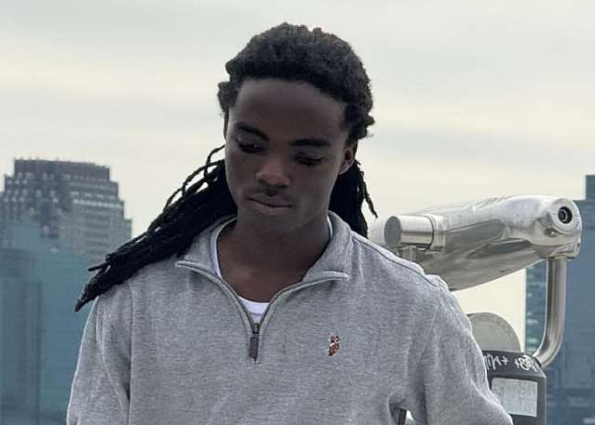 Young Ghanaian student Tyrone Marhguy working with salvaged electronic components and circuit boards