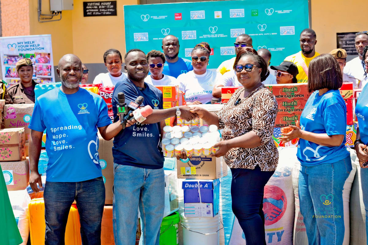 Donation boxes and supplies arranged outside prison facility in Ghana during charity outreach