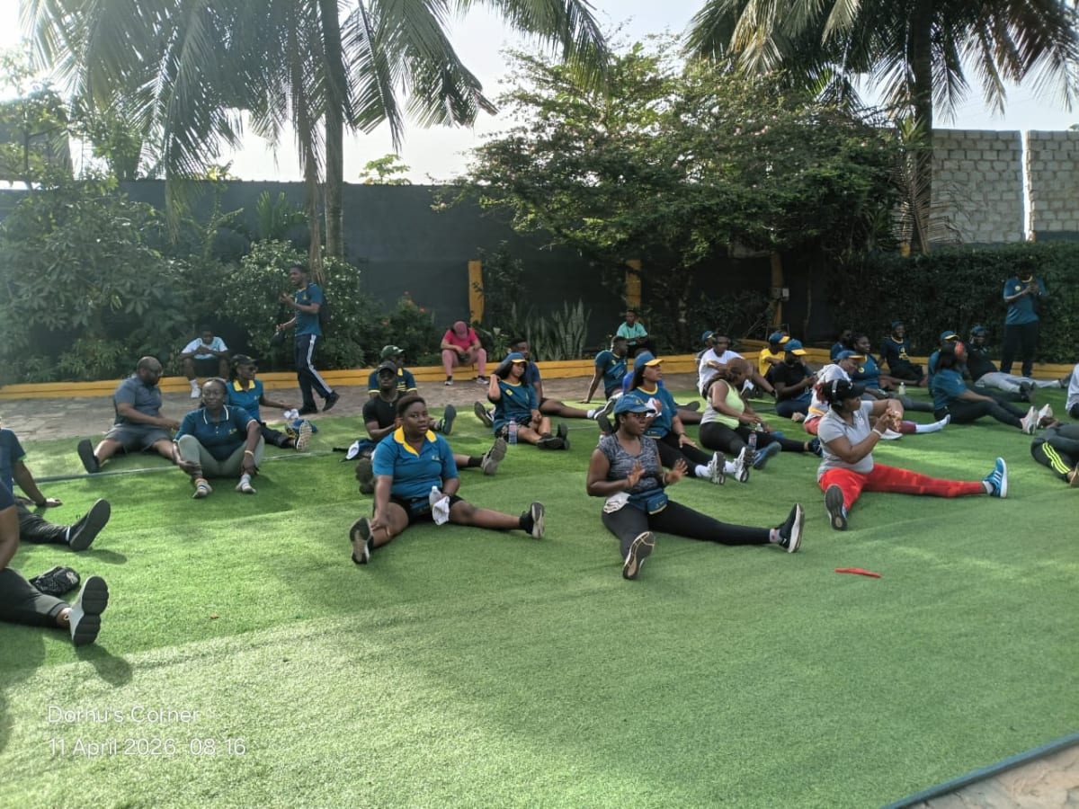 Large group of MTN Mobile Money staff walking together on mountain trail in Ghana