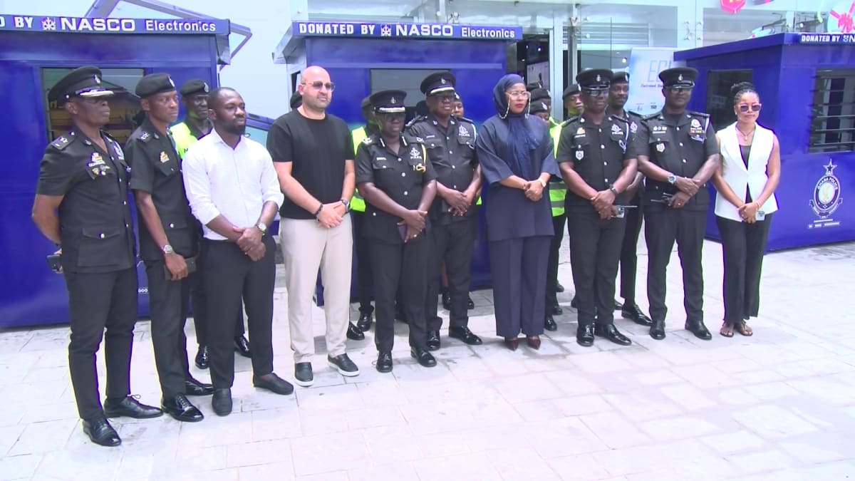 Mobile security kiosk sheltering police officer at busy traffic intersection in Accra, Ghana