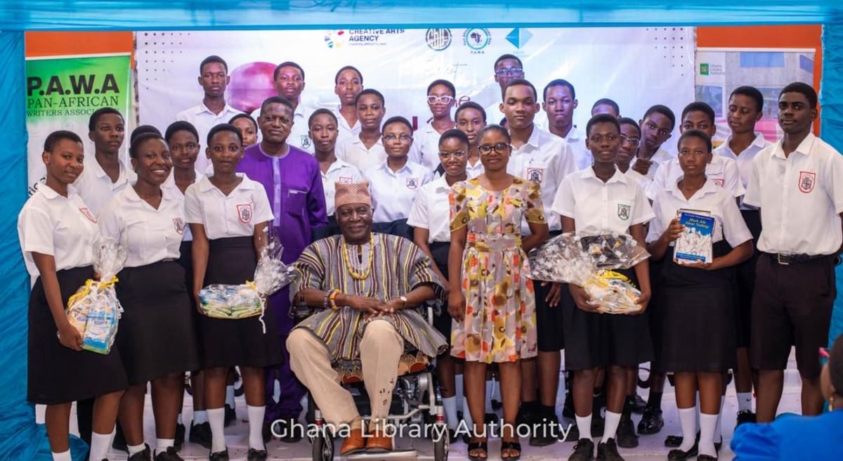 Ghanaian high school students performing poetry on stage at library competition
