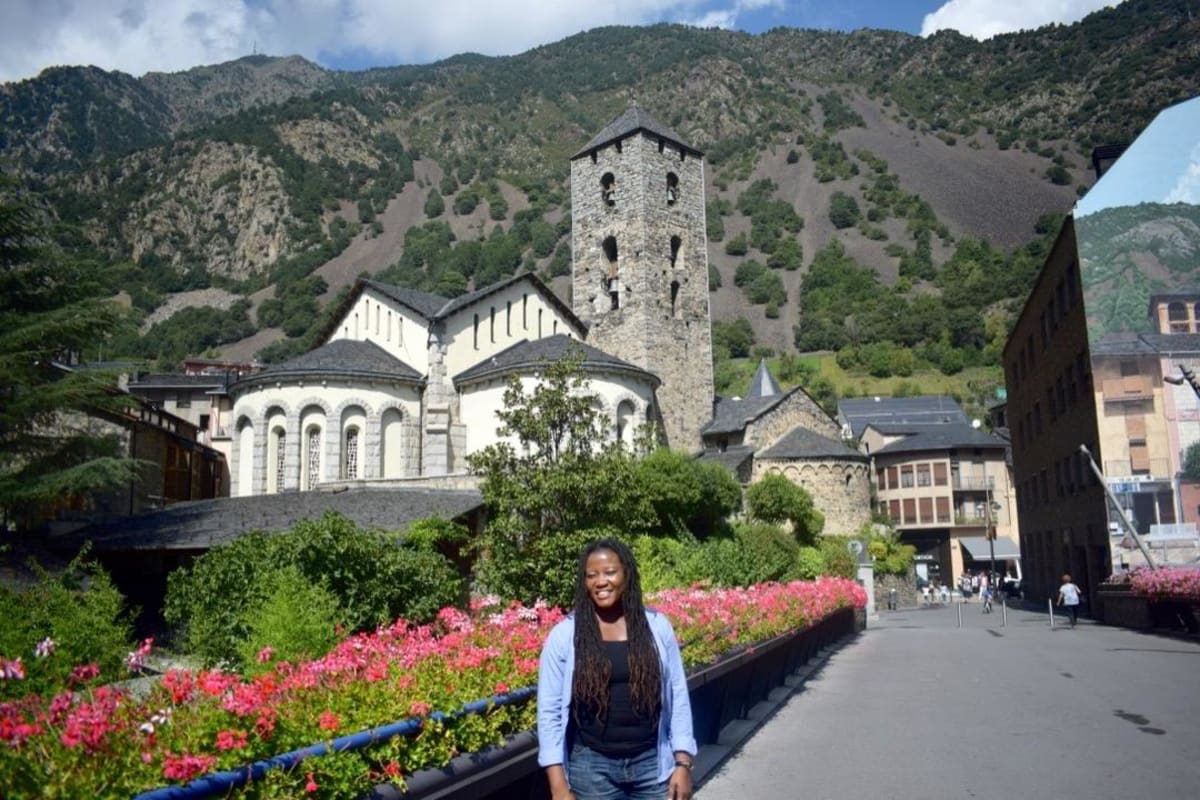 Princess Umul Hatiyya standing at an international landmark during her solo travels across 90 countries