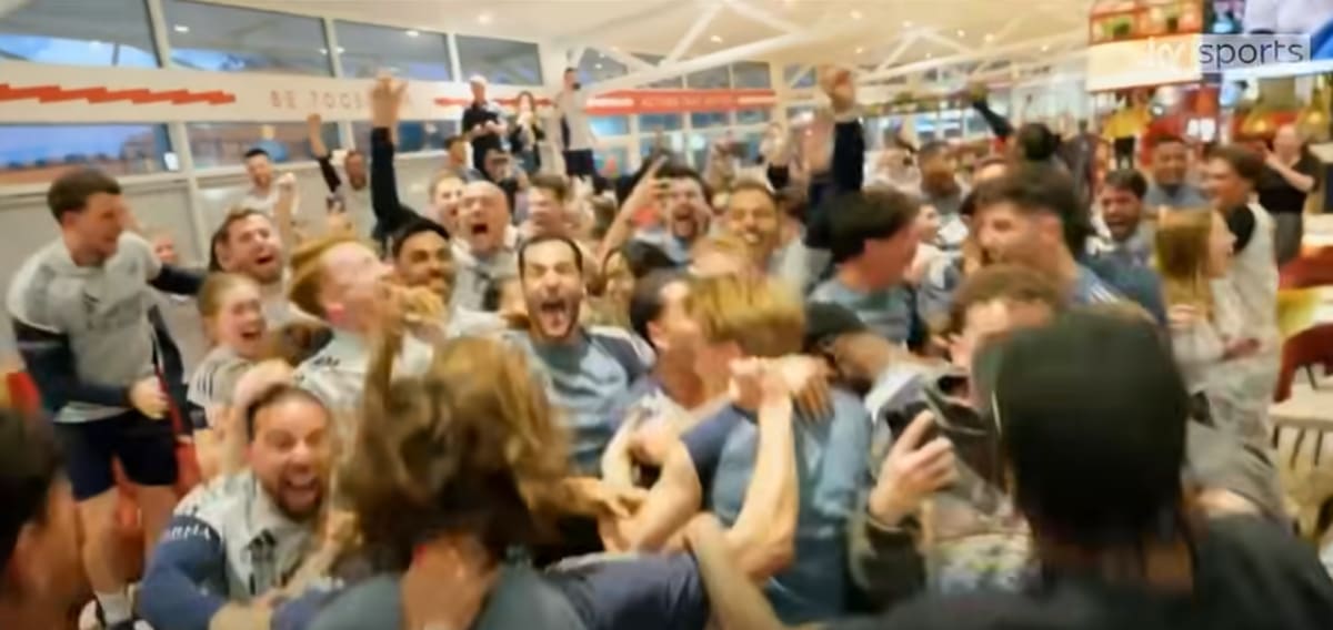 Arsenal players and staff celebrating together at training ground after winning Premier League title