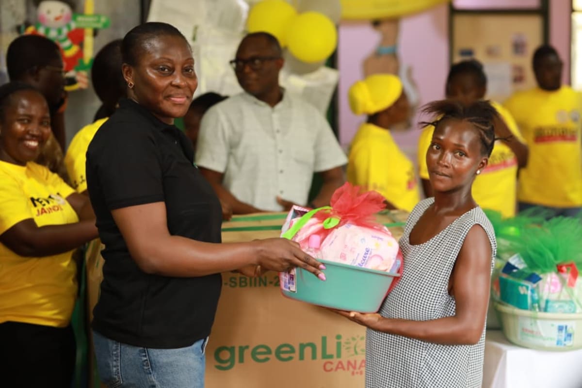 Healthcare workers with baby incubator in Ghanaian hospital celebrating medical equipment donation
