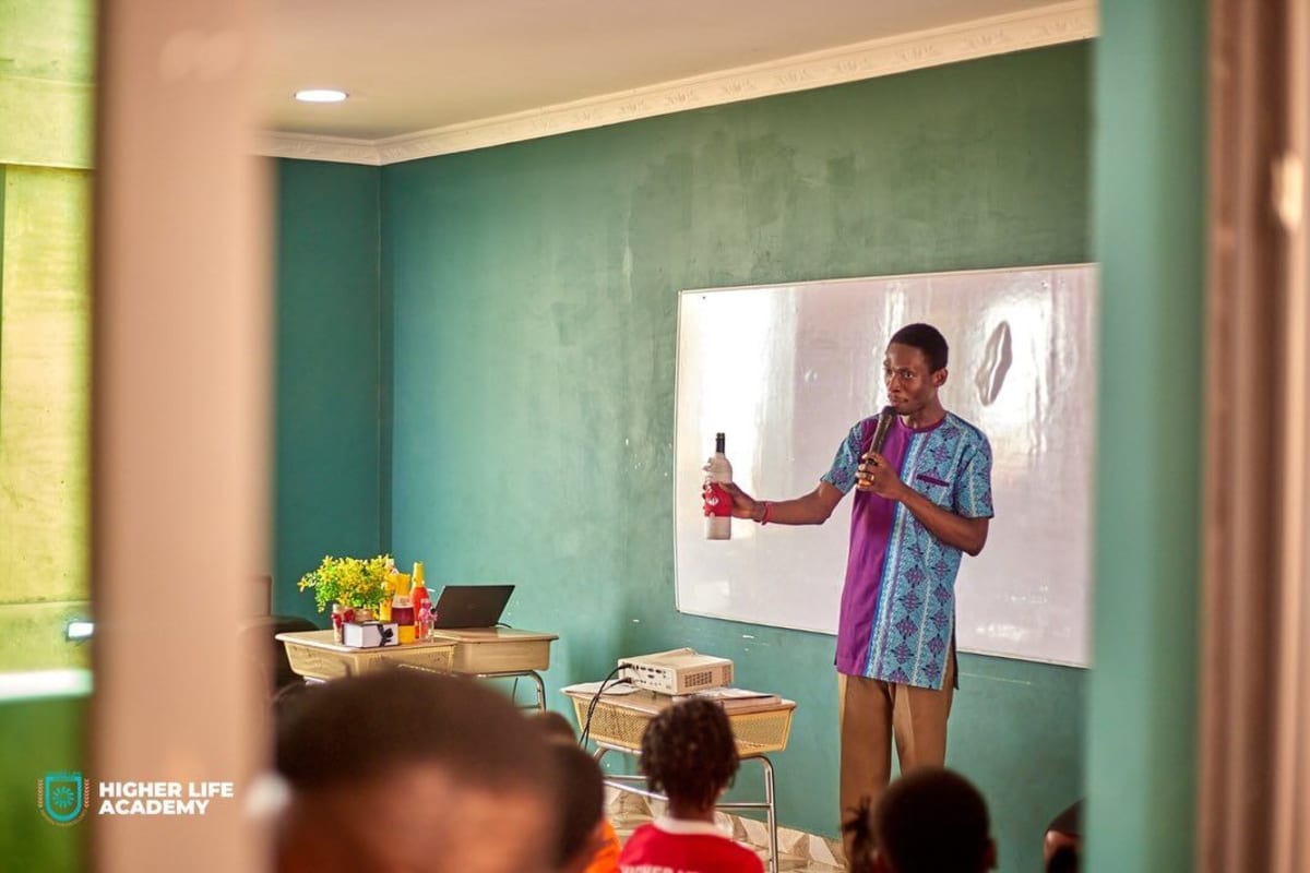 Ghanaian students at Higher Life Academy discussing creative recycling solutions for plastic waste transformation