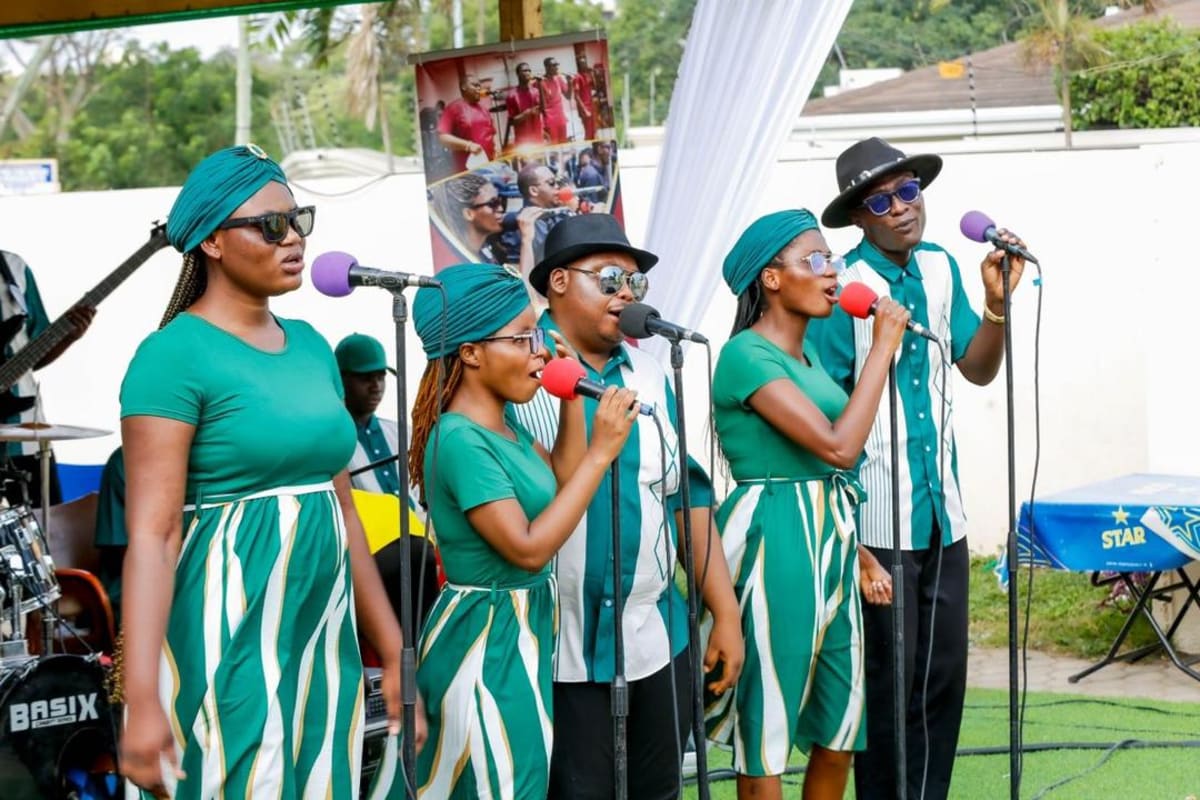 Visionary Rhythms Band members performing with musical instruments on stage in Ghana