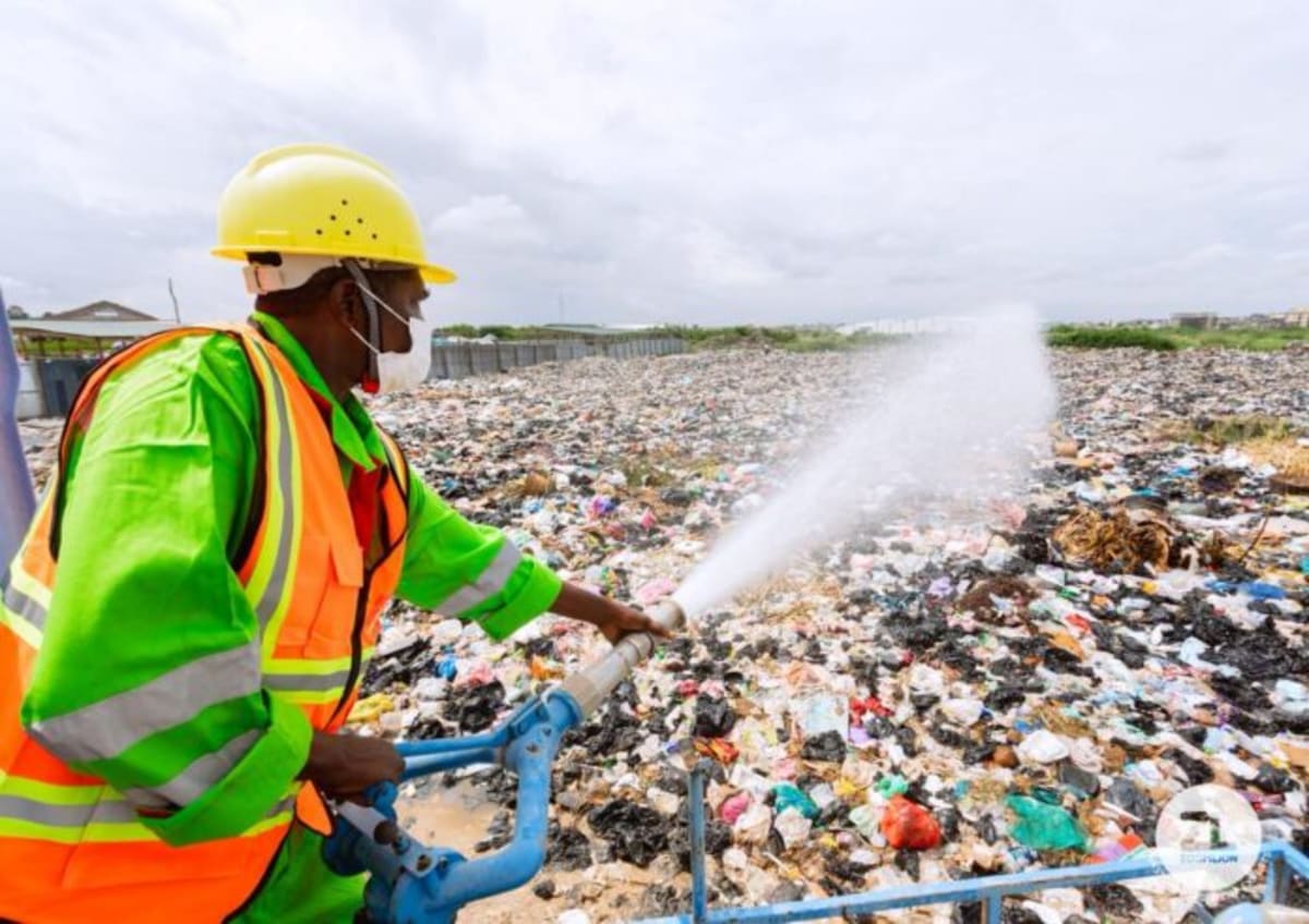 Fumigation teams in protective gear disinfecting flooded Accra neighborhoods to prevent disease outbreaks