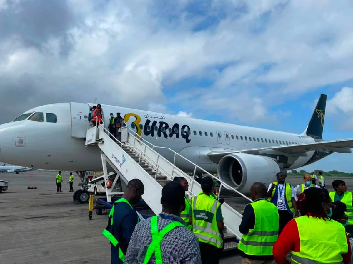 Ghanaian migrants arriving at Accra International Airport greeted by government officials and support staff