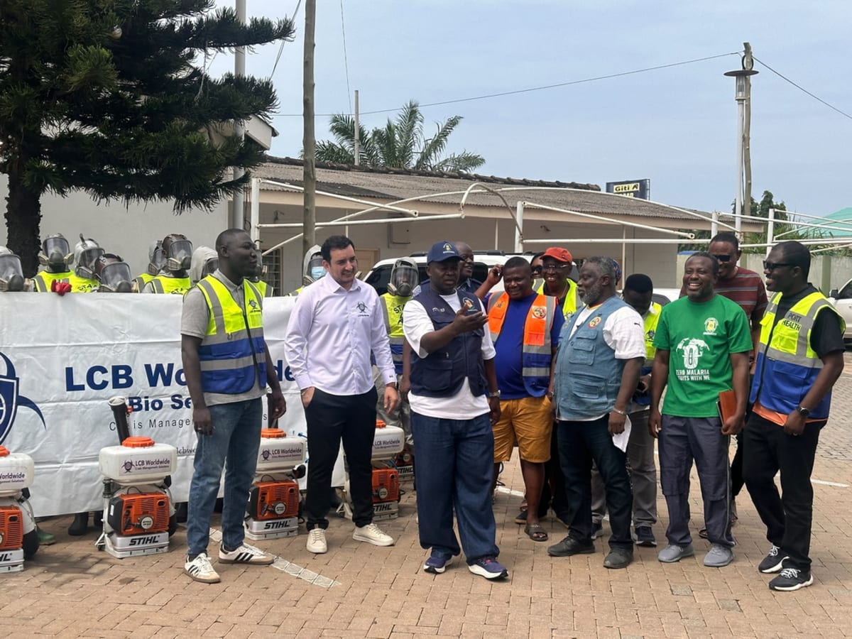 Health workers conducting fumigation operation in crowded Accra market to prevent disease outbreaks