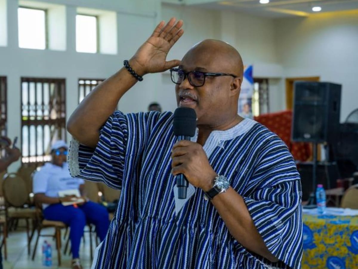 Group of Ghanaian artists and creatives participating in community cleanup with cleaning tools