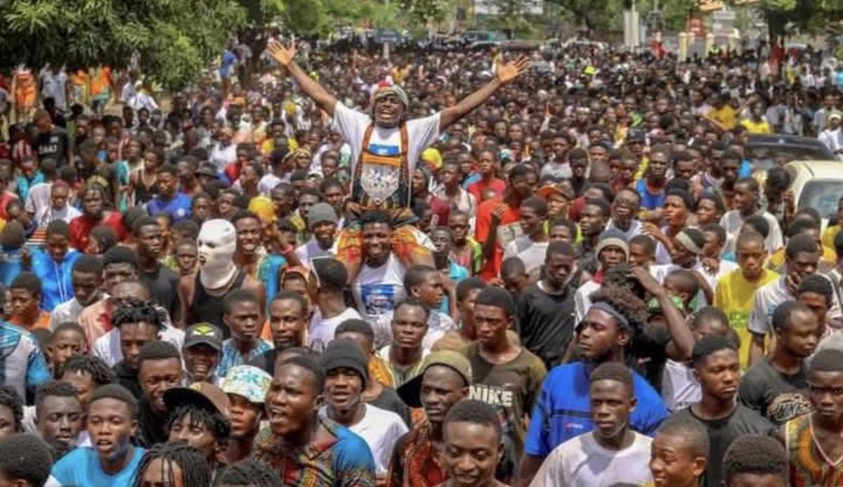 Young people in colorful traditional dashiki clothing celebrating at Ghana's community youth festival