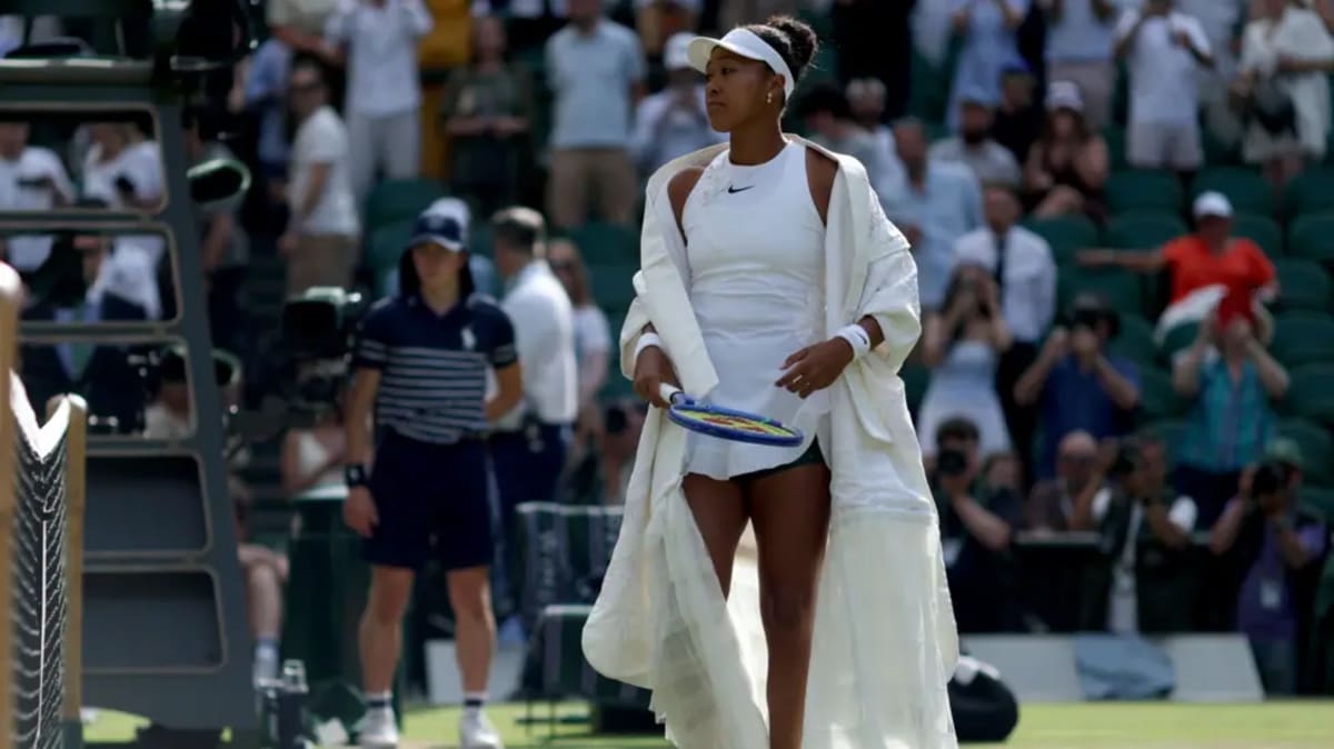 Naomi Osaka smiling and celebrating on Wimbledon Centre Court after defeating world number one