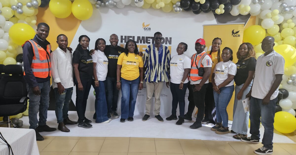 Motorcycle riders in Accra Ghana receiving safety training and helmet education from bank volunteers