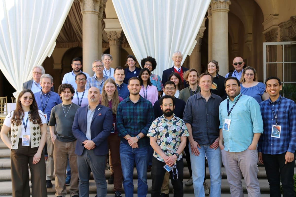 Research team stands holding Nature Astronomy magazine cover featuring NASA starshade exoplanet observatory concept