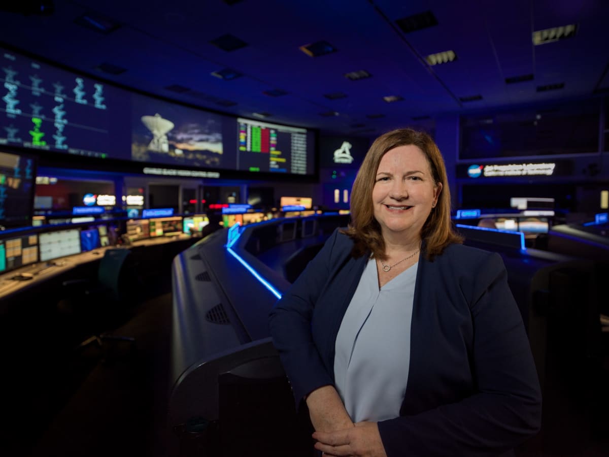 NASA engineer Kathleen Harmon stands in Mission Control Center at Jet Propulsion Laboratory