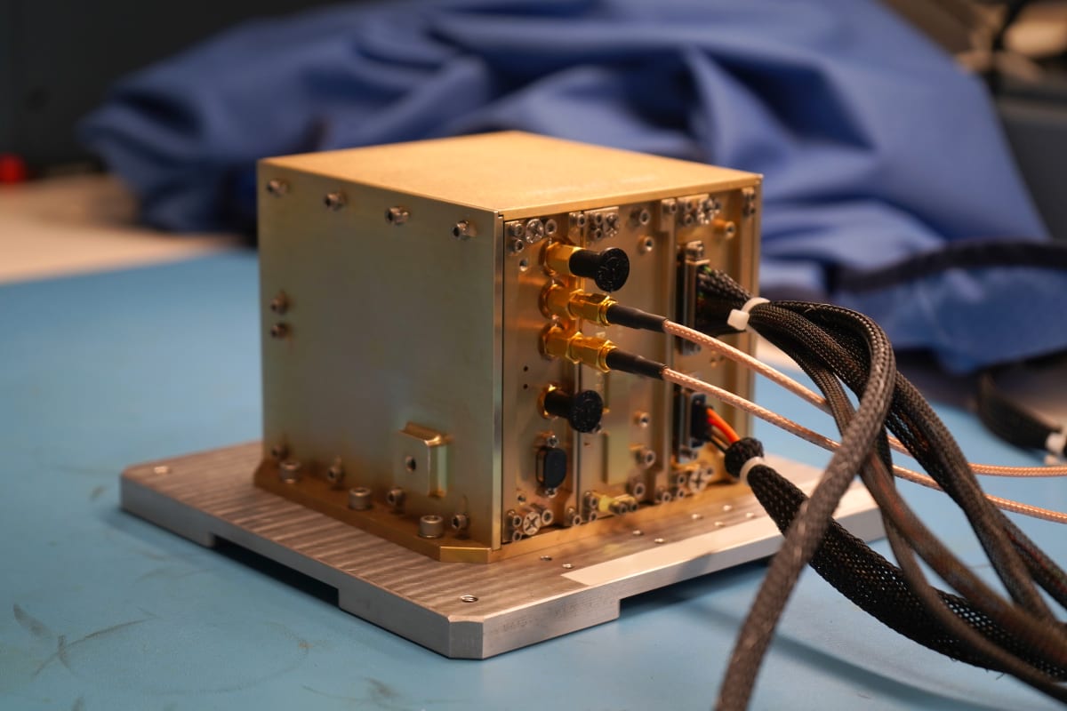 Small cube-shaped navigation device sitting in NASA laboratory before lunar mission delivery