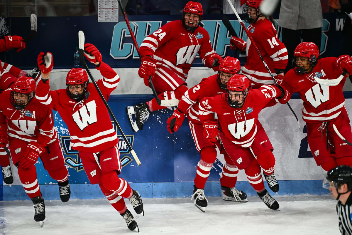 Wisconsin Badgers women's hockey team celebrates with national championship trophy on ice