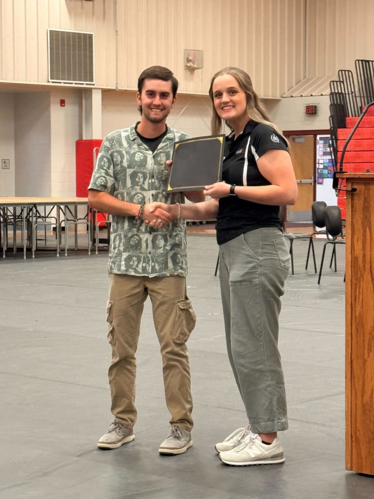 High school senior Malaki Phillips receiving scholarship check at Clark County awards ceremony