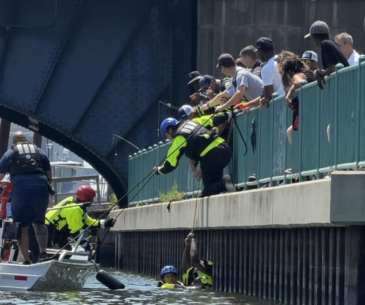 Kayaker preparing rescue equipment near Quinnipiac River seawall in New Haven Connecticut