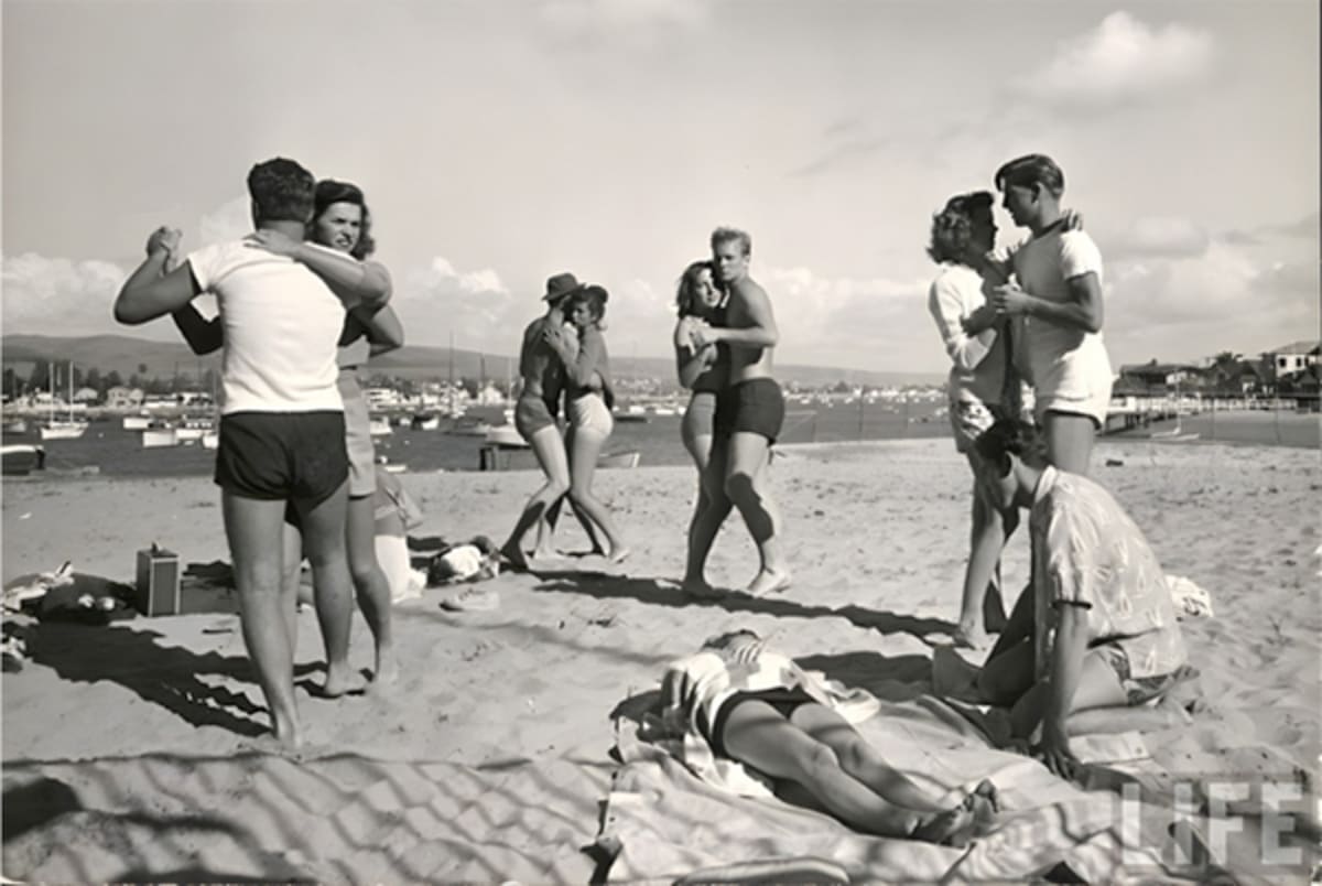 Couples swing dancing on the beach in Newport Beach, California at sunset
