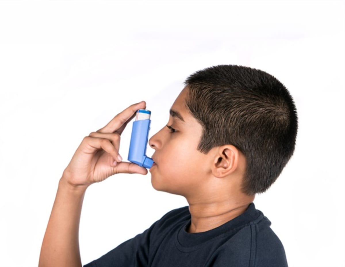 Scientist examining respiratory cells under microscope in modern medical research laboratory
