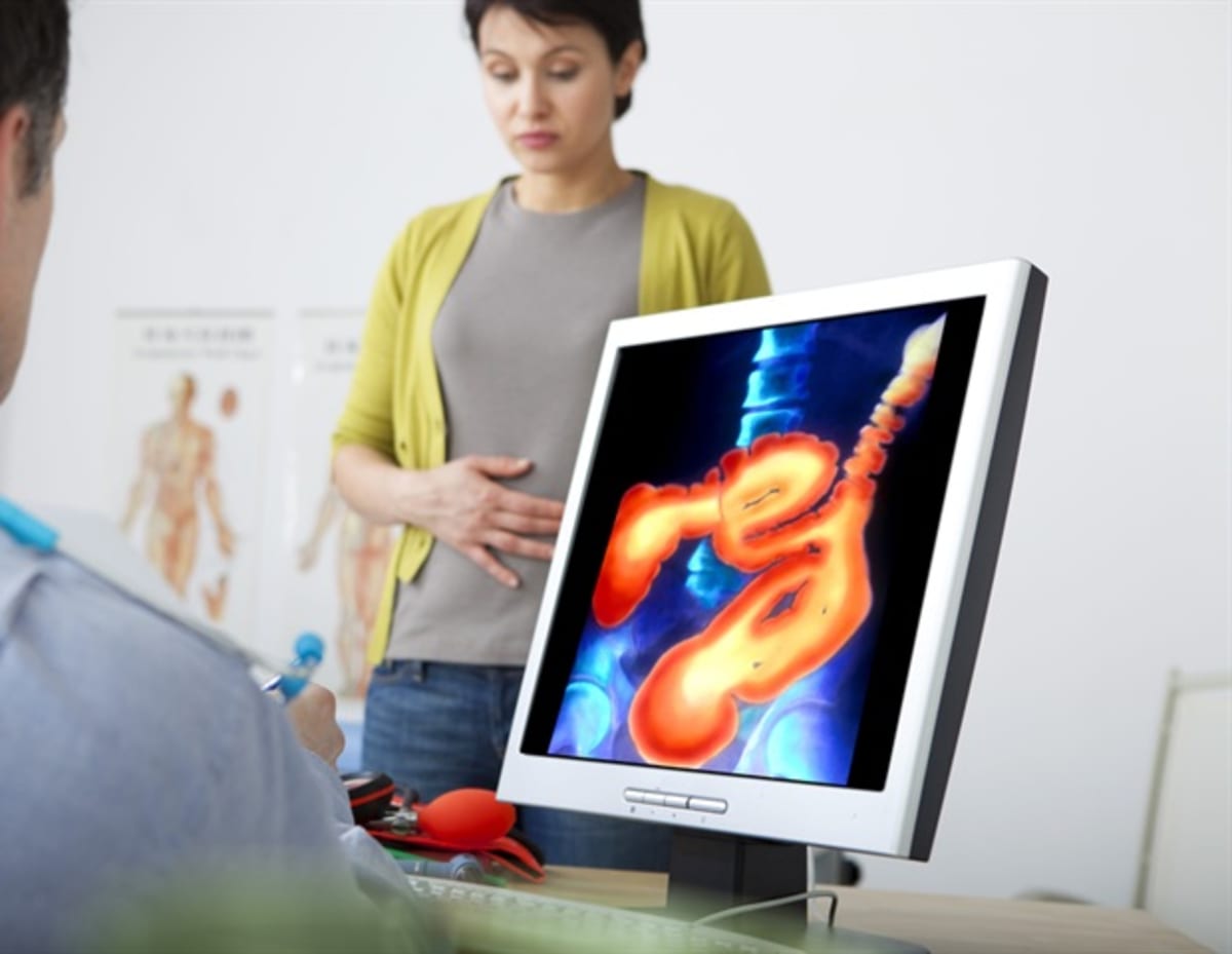 Scientists examining tissue samples under advanced microscopy equipment in modern research laboratory