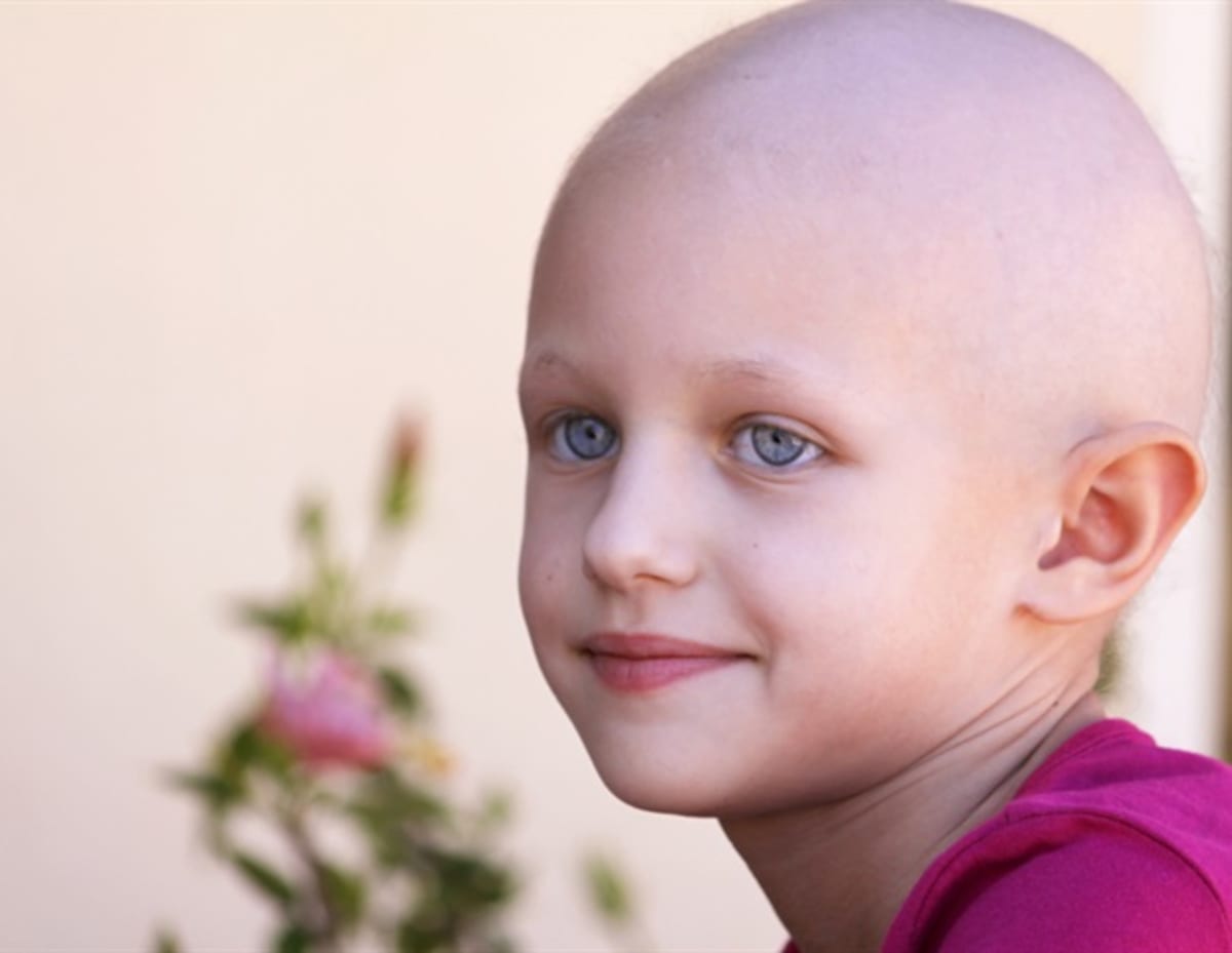 Scientists examining cancer cells under microscope in modern research laboratory setting