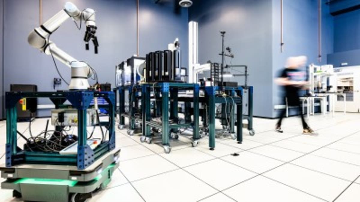 Scientists in modern laboratory with robotic equipment and AI technology systems conducting automated experiments
