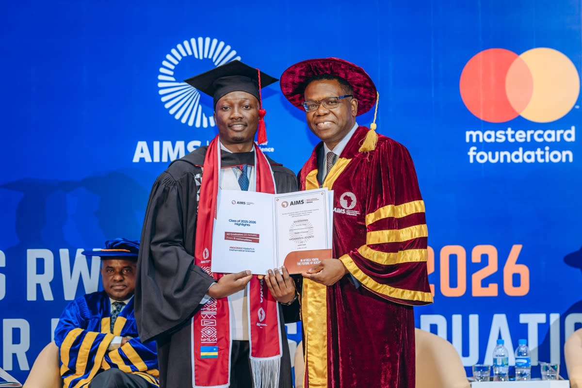 African graduate students in academic regalia celebrating at AIMS Rwanda commencement ceremony