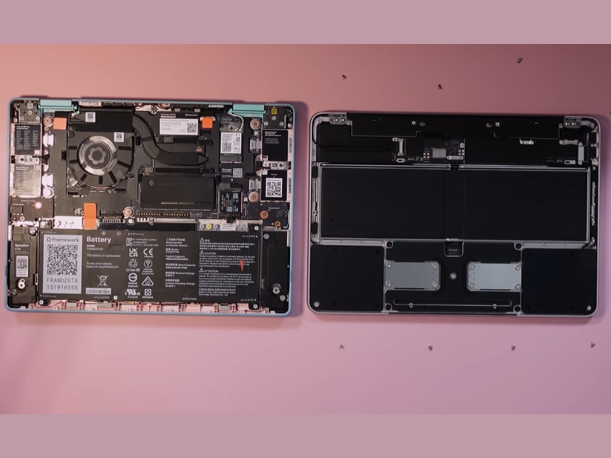 ** Framework CEO Nirav Patel comparing disassembled Framework laptop with Apple MacBook Neo components