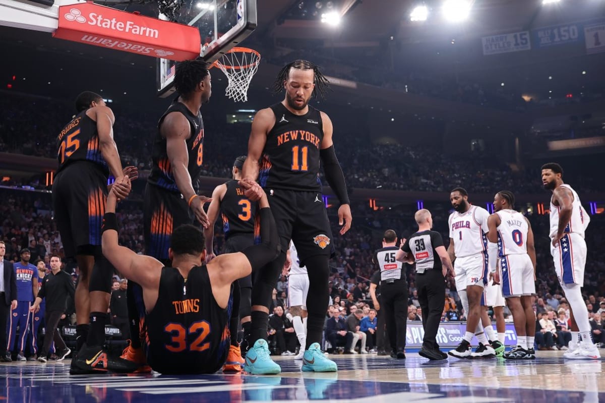 ** Karl-Anthony Towns helped up by Mikal Bridges and Jalen Brunson during NBA playoffs at Madison Square Garden