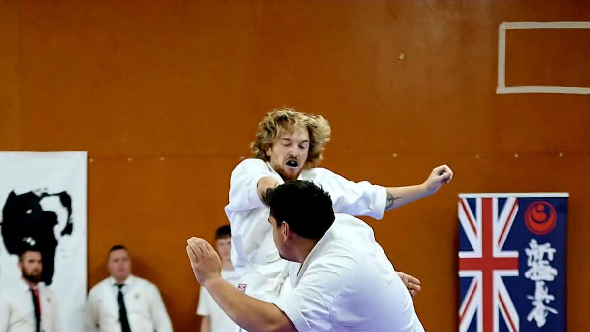 Young karate student Creed Norman exchanges kicks with opponent during full-contact match in Napier