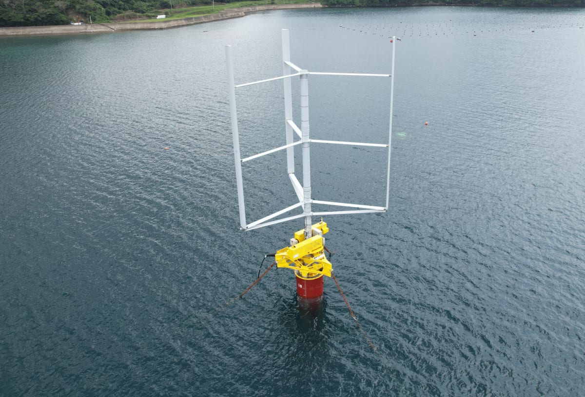 Cylindrical vertical-axis wind turbine with three straight blades floating in Japanese bay waters