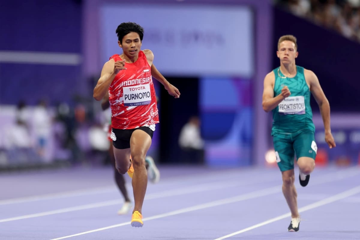 Paralympic athlete Saptoyogo Purnomo competing in track event wearing Indonesia uniform