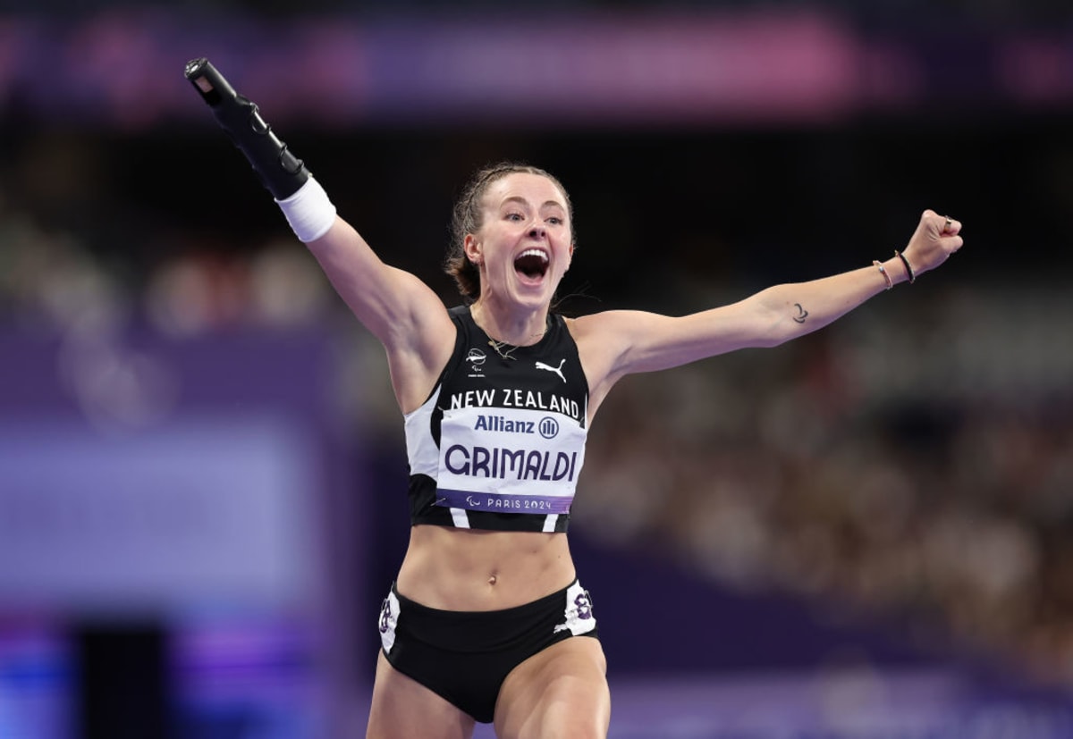 Paralympic champion Anna Grimaldi competing in track event wearing New Zealand uniform
