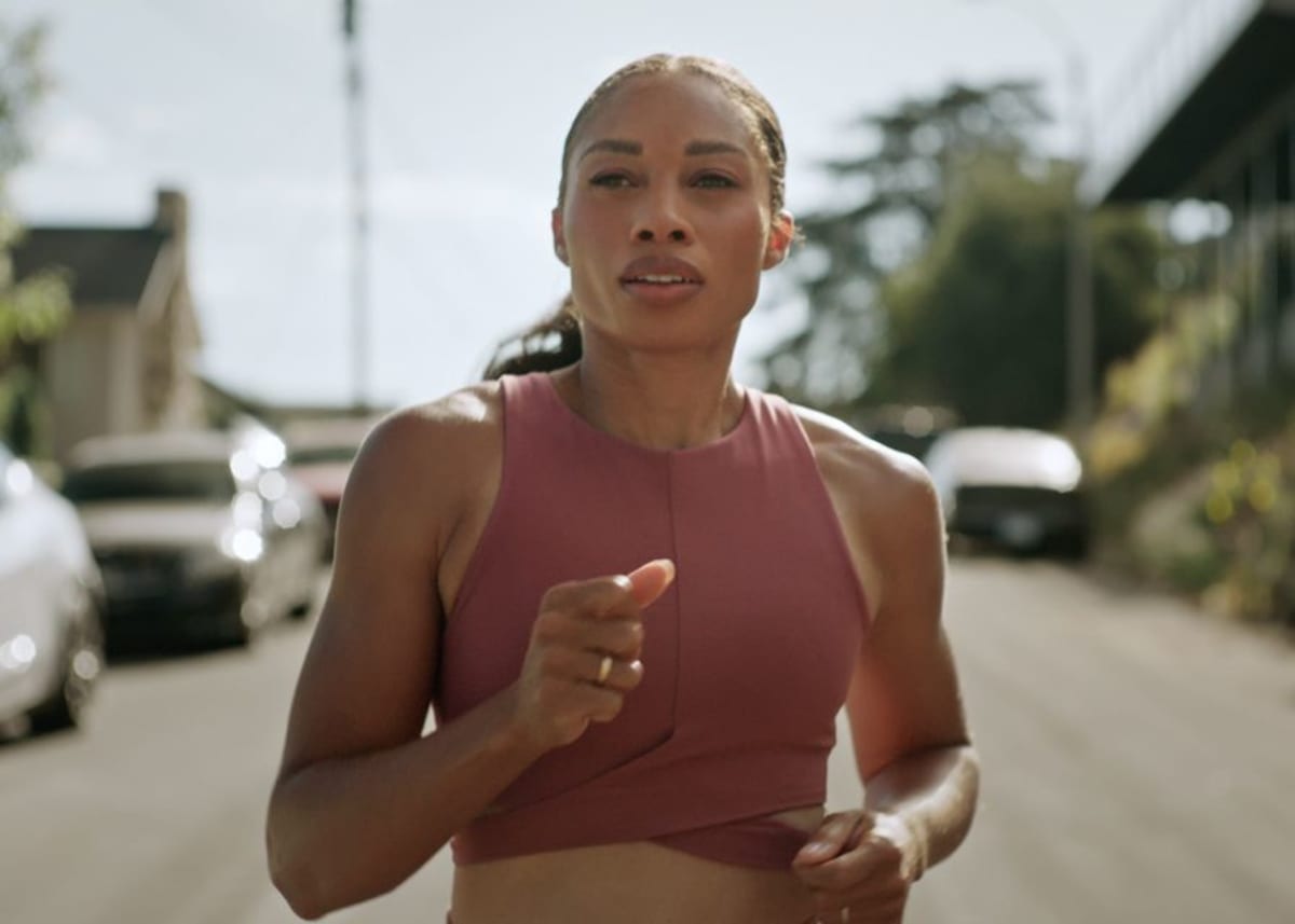 Olympic champion Allyson Felix running outdoors during training session in residential neighborhood