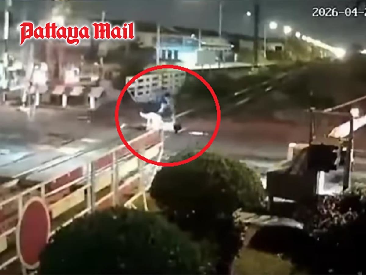 Railway crossing with safety barriers where heroic rescue saved motorcyclist from oncoming train