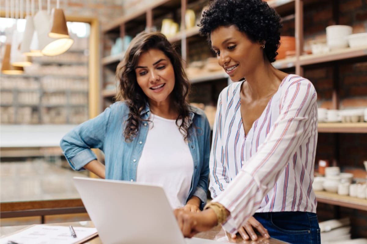 Small business owner shaking hands with community banker inside local bank branch